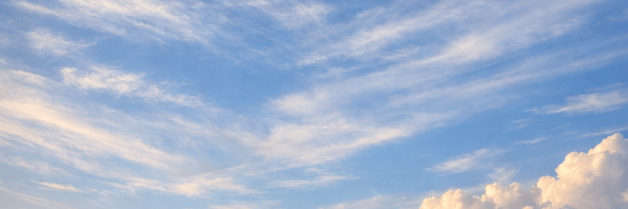 Coastal village with stone church steeple and thatched cottages by the ocean