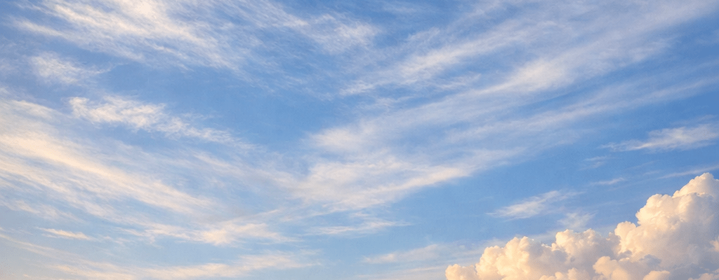 Coastal village with stone church steeple and thatched cottages by the ocean